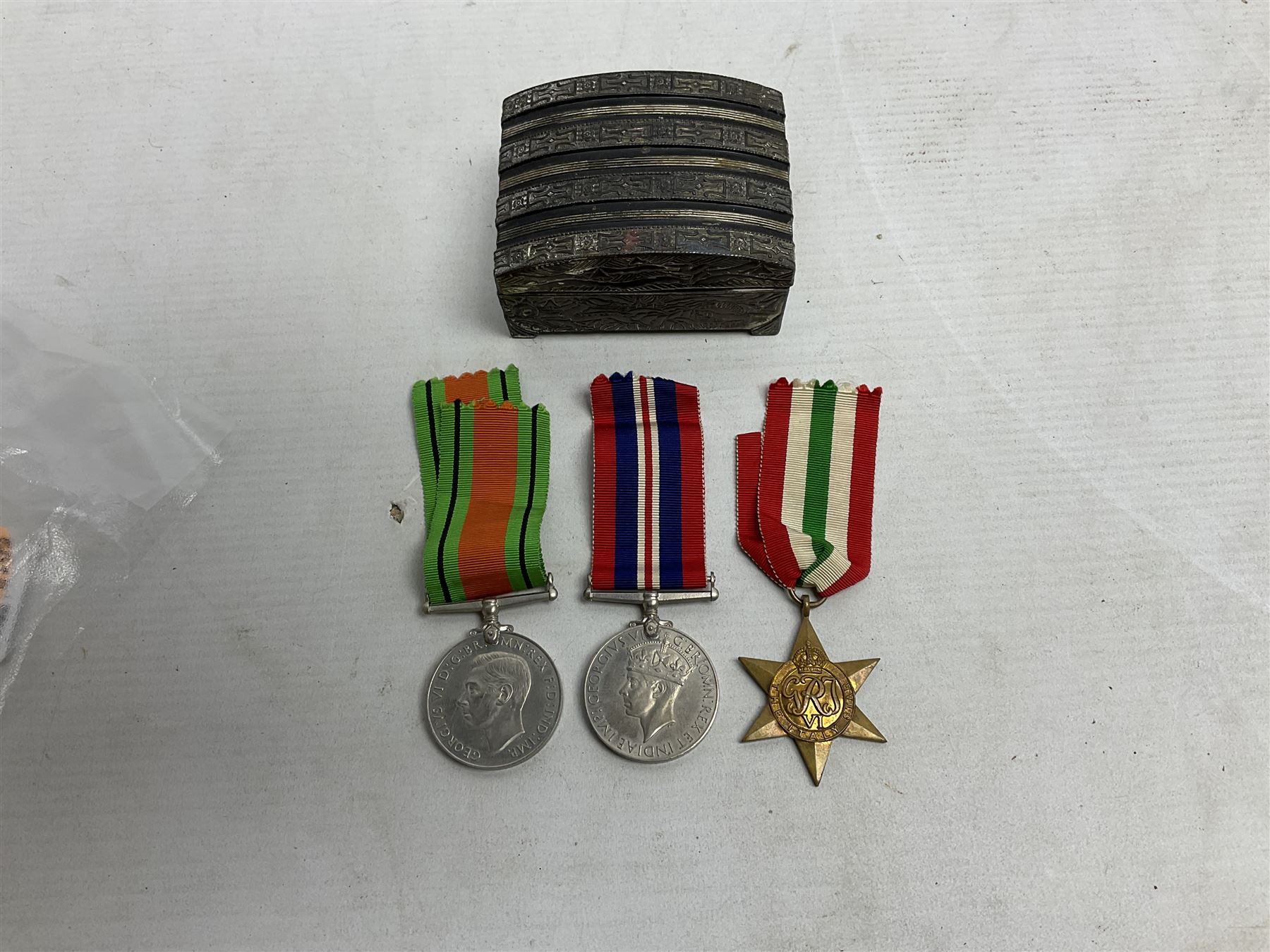 WWII service medal trio comprising Defence Medal, 1939-1945 medal and 1939-1945 Star, with various ribbons and box