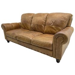 Three-seat sofa (W205cm, H95cm, D100cm); and matching two-seat sofa (W150cm); upholstered in stitched tan leather, on turned feet