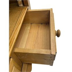 Early 20th century pine kitchen dresser, featuring a hutch with arched top over three open shelves, the base with five drawers over three cupboard doors, turned column supports flanking the doors, scalloped apron base with bracket feet