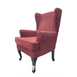 Wingback armchair upholstered in red fabric