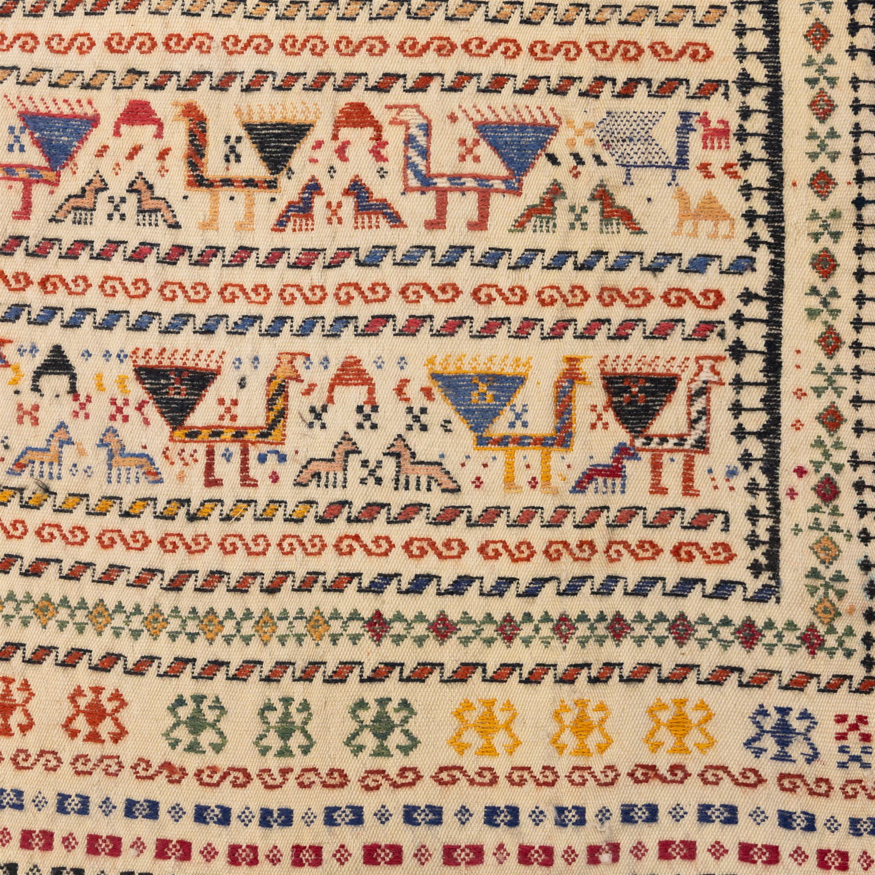 South West Persian Qashqai flatweave kilim horse cover, woven in flatweave with horizontal bands of stylized animals and geometric motifs, featuring repeated rows of horses and camels and abstract figures interspersed with serrated and meander bands, enclosed within simple geometric borders 