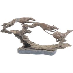 Bronzed sculpture of three greyhounds running at speed, on naturalistic base and oval plinth, L54cm H26cm 