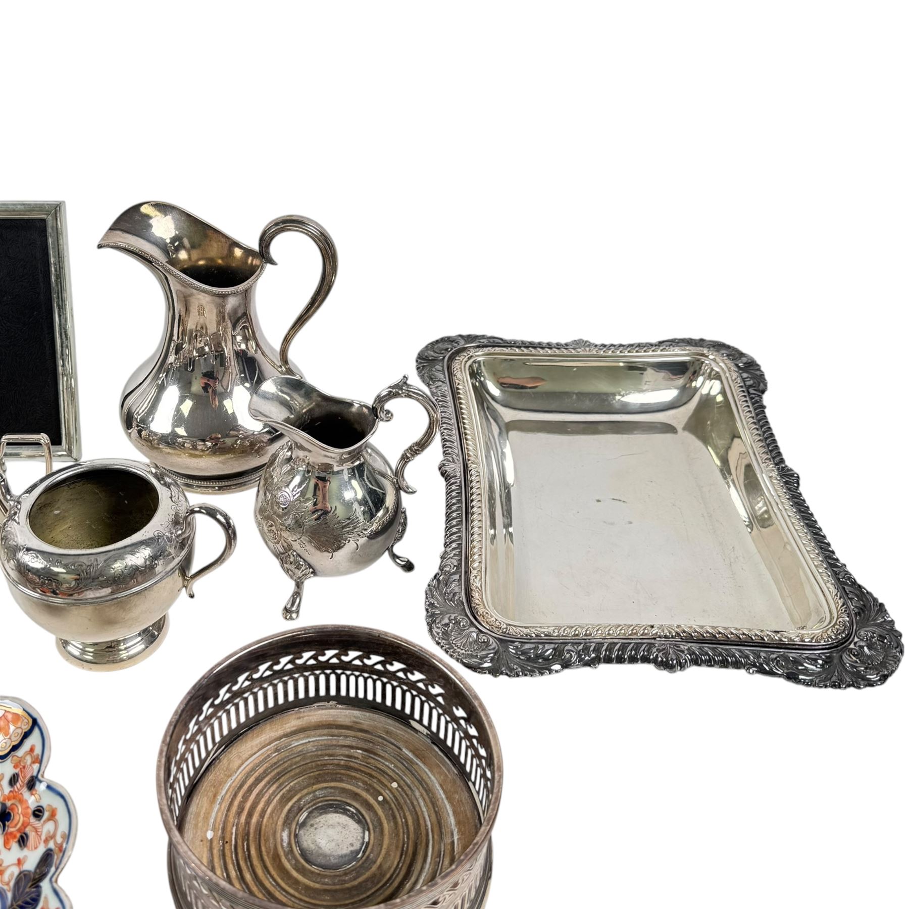 Silver plated items, including thee pairs of bottle coasters, sugar caster, Elkington jug, chamberstick etc and a Japanese Imari scalloped charger