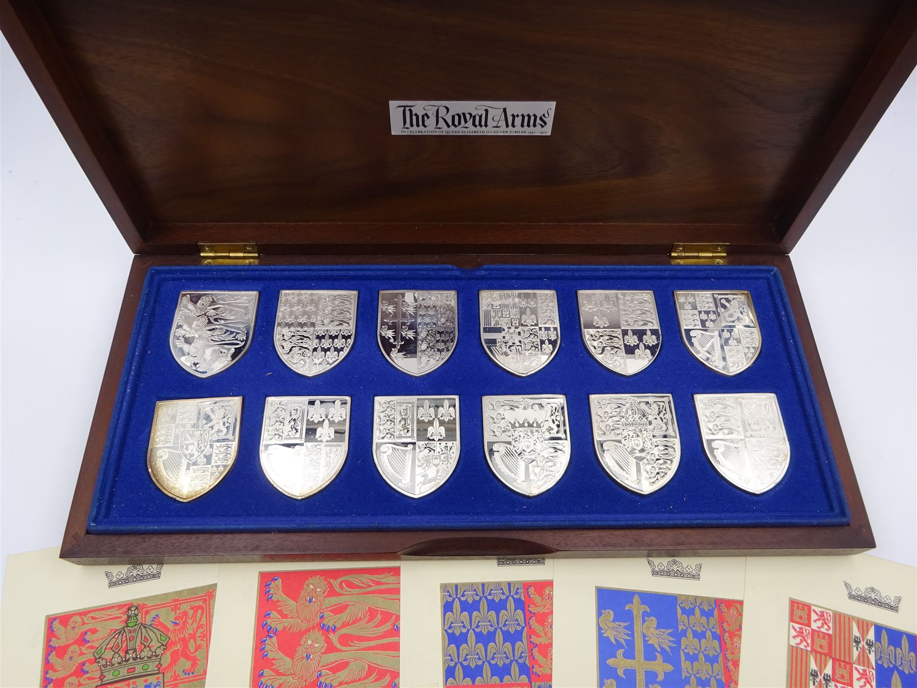 Yorkshire Mint, The Royal Arms Collection, twelve shield shaped silver medallions each depicting variations on the Royal coat of arms, each hallmarked Yorkshire Mint, Birmingham 1976/77, contained within fitted wooden case with associated information cards
