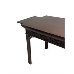 In the manner of Thomas Chippendale - early 19th century mahogany serving table, rectangular crossbanded top with boxwood stringing, the frieze with upper moulding over applied geometric fretwork, the left-hand side fitted with slide, on fluted square supports with inner chamfer 
