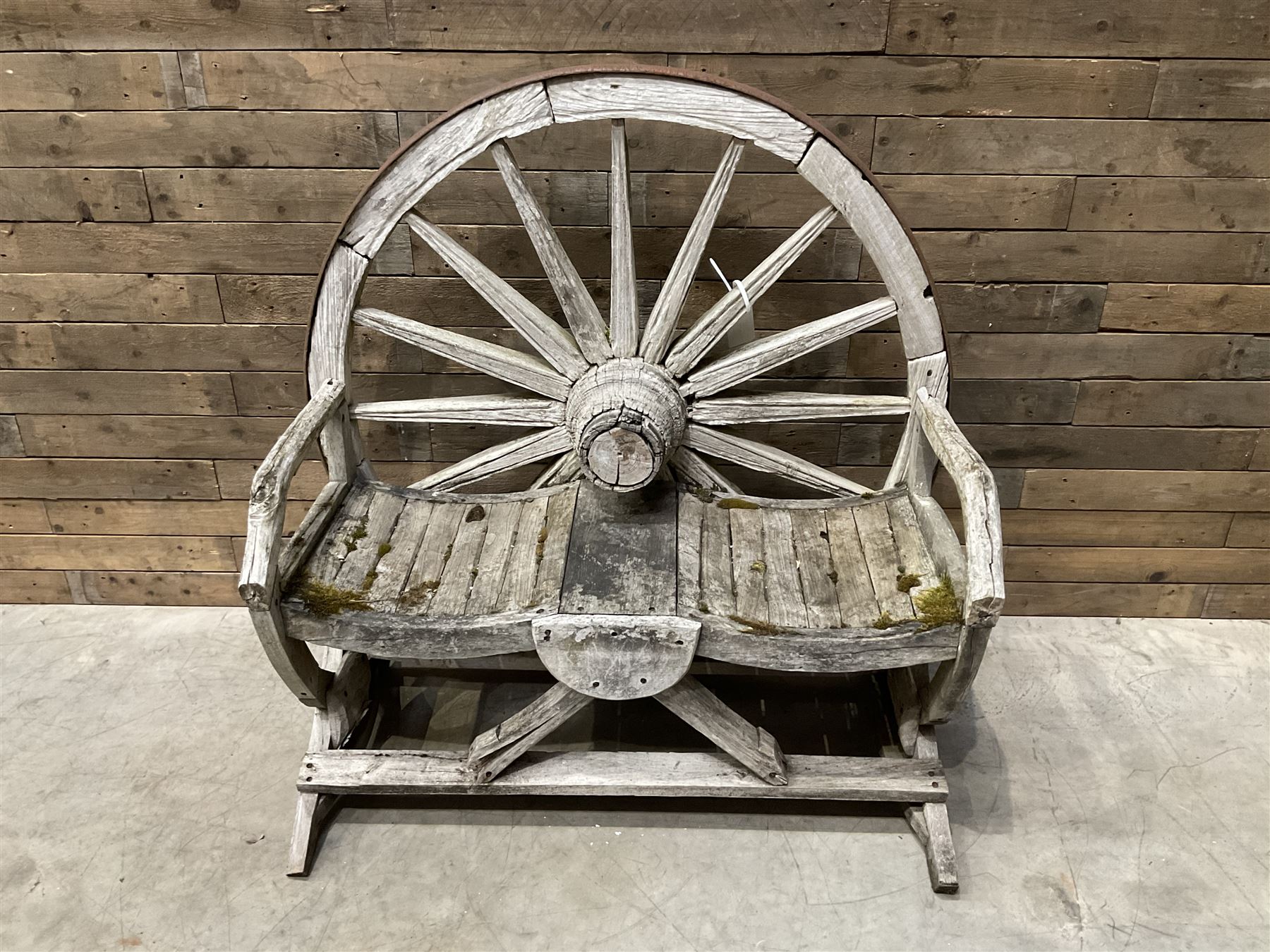 Early 20th century timber framed cartwheel garden bench