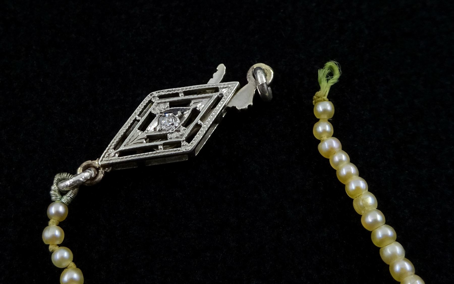 Three strand pearl necklace, with platinum diamond milgrain clasp and a single strand graduating pearl necklace with 18ct white gold clasp set with a diamond