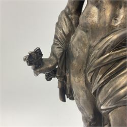 20th century silver plated figure, modelled as a classical male figure, possibly Prometheus, holding flames, one foot resting atop a small dragon, upon a circular spreading base, overall H37.5cm