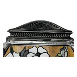 Stained glass and cast iron electric fireplace, arched top with decorative finials, stained glass front panel with floral motifs, flanked by cast iron scrolls, raised on scroll supports