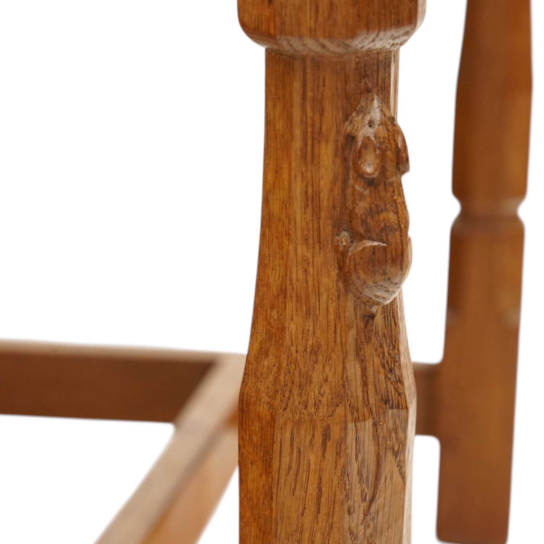 Mouseman - set of six (5+1) 1940s pre-war panel-back dining chairs, the raised backs with adzed panels, over seats upholstered in tan leather with studwork border, raised on octagonal turned baluster supports united by box stretcher, with carved mouse signature, by the workshop of Robert Thompson of Kilburn

Provenance: ordered directly from the Mouseman workshop in the 1940s before the outbreak of the war, the items were subsequently delivered after the end of war. 