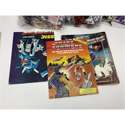 Four 1980sTransformer G1 - Optimus Prime 1984; DinoBot Sludge (Diplodocus) 1984; Cyclonus 1986; and Runamuck 1986; with paperwork; seven Bandai Robo Machines Robots/Transformers; almost fully stocked Panini Sticker album; two annuals; three comics; two posters; and Ladybird story book