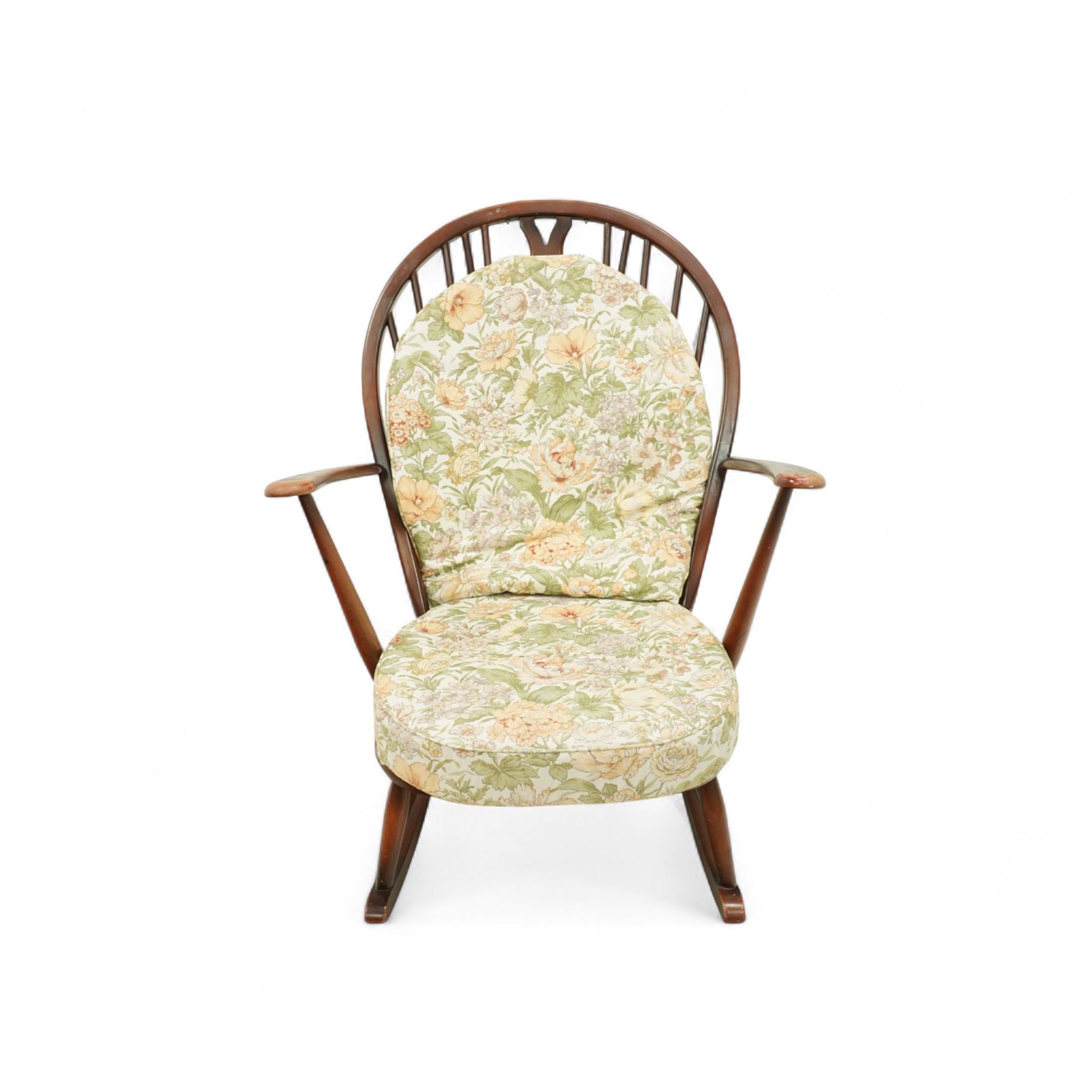 Ercol - Mid-20th century ‘Fleur-de-Lis’ rocking chair, elm and beech frame with curved arms, pierced back crest and stick supports, floral upholstered seat and back cushions, on curved rockers