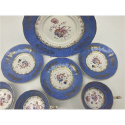 Set of three Victorian teacups and saucers, with matching dessert plate, decorated with a watered silk blue boarder and hand painted floral sprays to the centre 