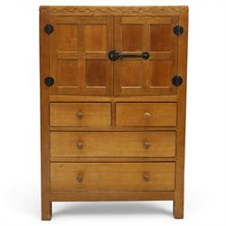 Mouseman - mid-20th century adzed and panelled oak tallboy chest, arcade carved cresting rail over two panelled cupboard doors with wrought iron fittings and latch, enclosing single shelf, over two short and two long drawers with lightly adzed facias and turned knob handles, raised on square supports, relief carved mouse signature, by the workshop of Robert Thompson of Kilburn