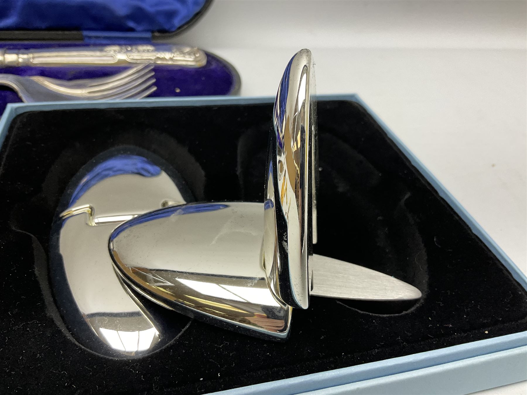 Cased pair of Wedgwood silver-plate book stands, silver-plate baby feeding spoon and pusher in box, other silver-plated cutlery