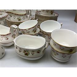 Wedgwood dinner service decorated in the 'Bianca' pattern, to include eight dinner plates, eight bowls, eight side plates, eight twin handled souo bowls, eight soup bowl saucers, eight teacups, eight teacup saucers, six dessert plates and two larger, two twin handled lidded tureens, milk jug, two sauce boats, salt and pepper shakers, oval serving  plate, twin handled sandwich plate, covered sucrier, small rectangular dish and two small circular dishes, all with printed stamp mark beneath