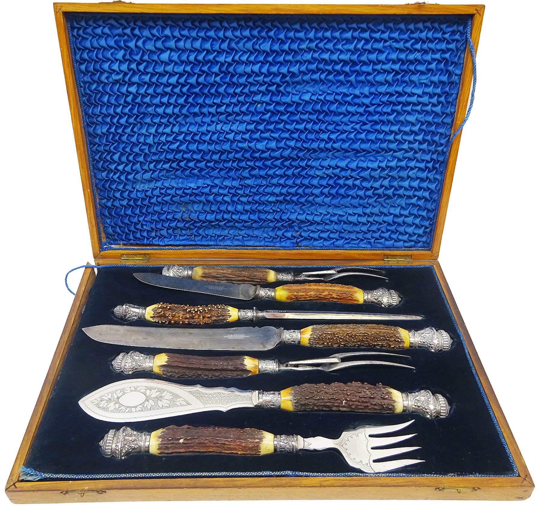 Victorian seven piece silver mounted antler handled carving set, the silver ferrules and terminals embossed with deer masks and fruit swags, hallmarked Francis Cholerton, and Mappin Brothers, Sheffield 1888, two steel blades stamoed J H Potter Cutler & Silversmith Sheffield, and one prong stamped J H Potter, contained within a fitted mahogany case with vacant brass cartouche to the hinged cover 

