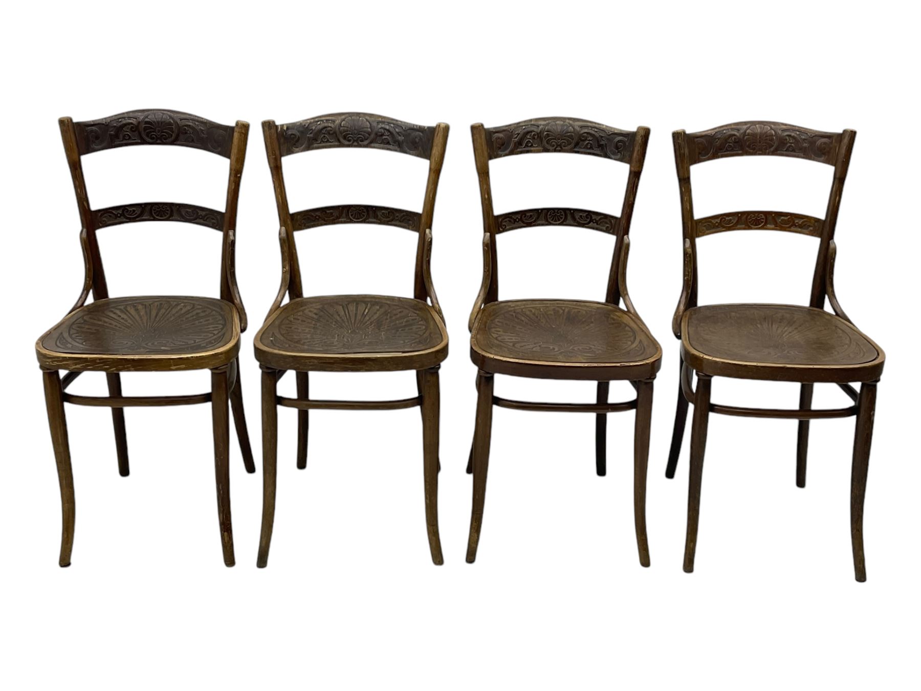 Jacob & Josef Kohn - set of four early 20th century Austrian bentwood chairs, each with carved decoration to the shaped backrest and shaped seat, on splayed supports with stretchers, marked with the manufacturer's stamp and paper label beneath