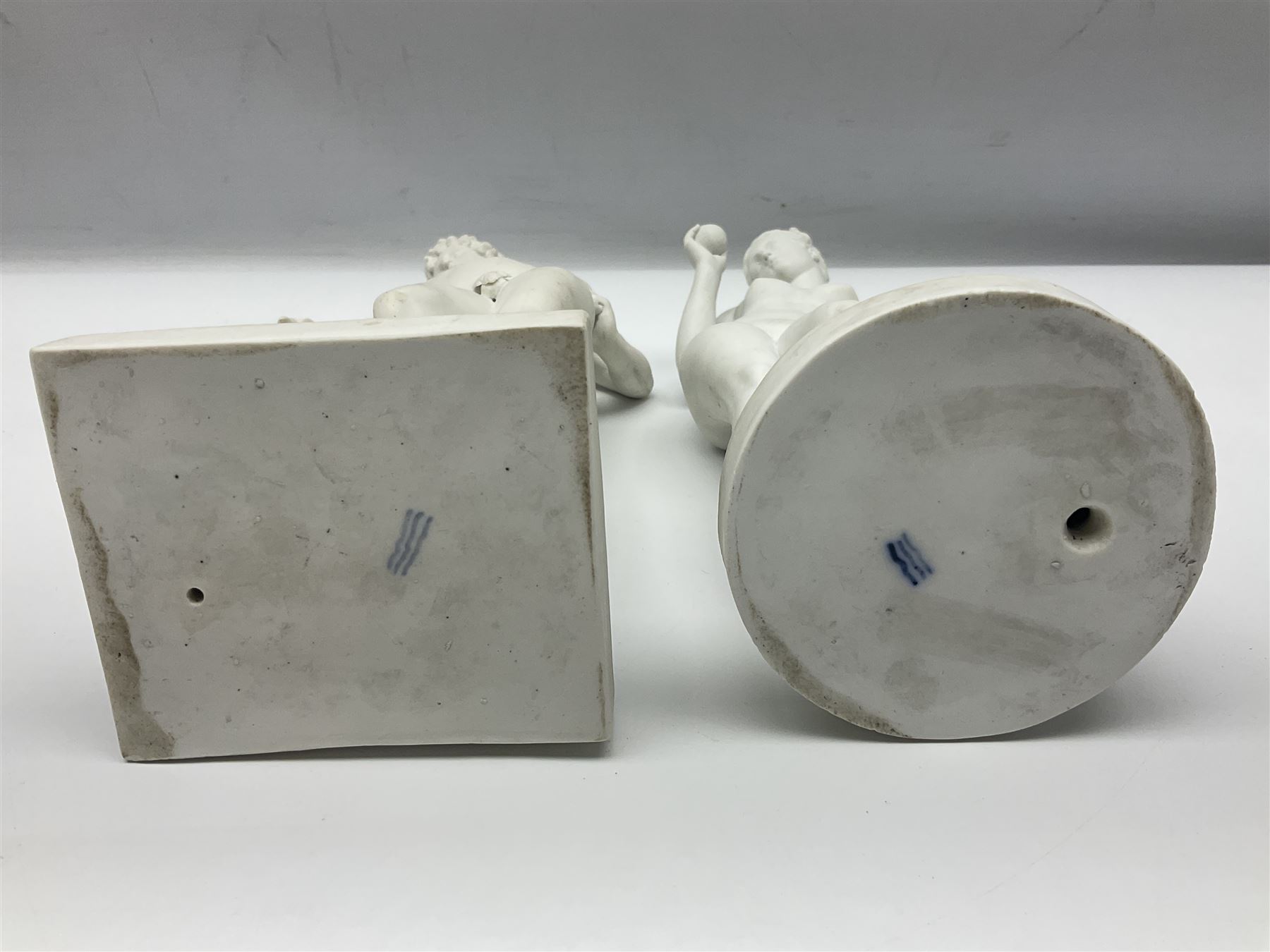 Royal Copenhagen Parian ware figure, modelled as Adonis, standing contrapposto by a tree trunk, together with a similar Parian ware figure, modelled as Venus with the Apple, both after Bertel Thorvaldsen and stamped Eneret to base with blue wave marks beneath, tallest H31.5cm