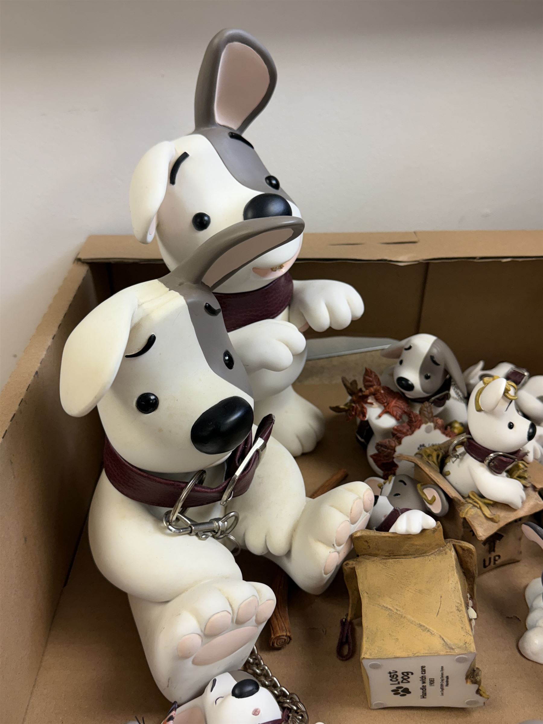 Collection of Craig Davison Xystos 'Lost Dog' figurines, including two larger examples 'This Game Takes Two' and 'Sit!', and smaller examples including 'A Christmas Shared' and 'Handle With Care', largest H28cm