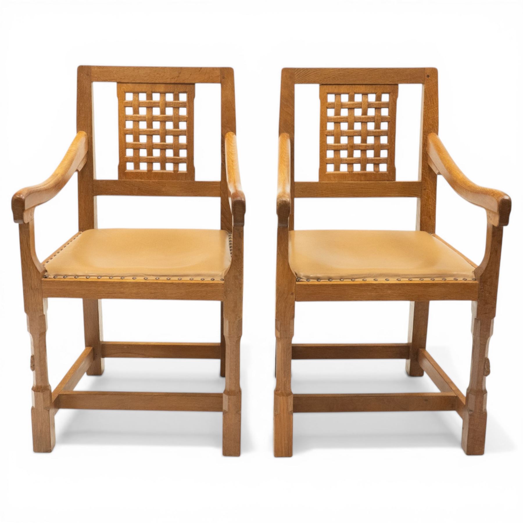 Rabbitman - pair of Yorkshire oak carver open armchairs, pierced and carved lattice back over tan leather seat with studwork, raised on octagonal supports united by H stretchers, carved with rabbit signature, by Peter Heap of Wetwang