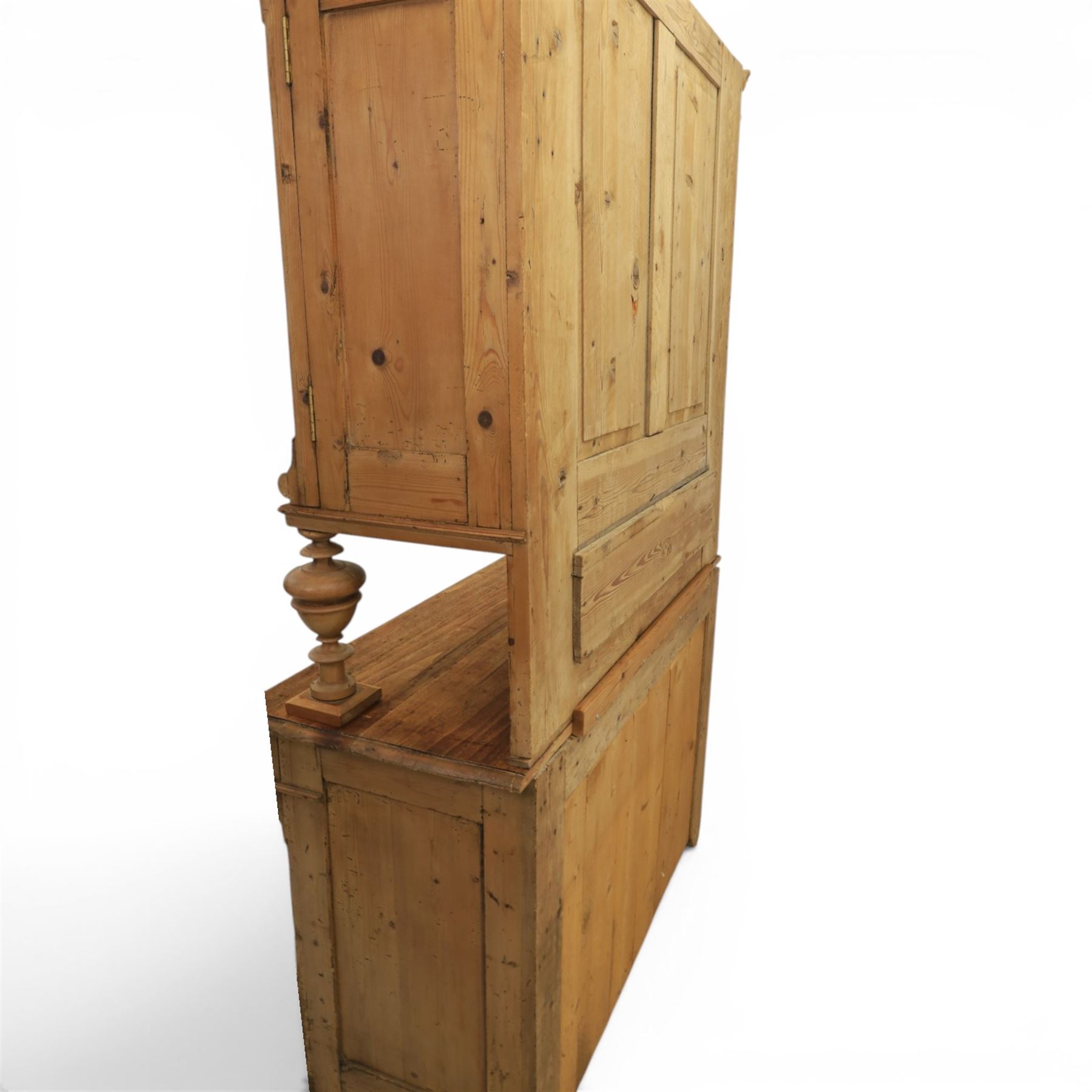 Late 19th century French pine dresser with stained glass upper section, the upper section with projecting cornice with fluted and scrolled details, enclosing a shelved interior, supported on turned front uprights, the lower section with frieze drawers and cupboard doors, raised on bun feet