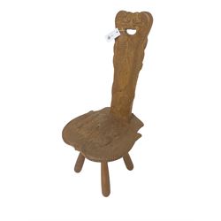 Small oak spinning chair, the shaped seat and back carved with scaled sea creatures and scrolls, on four turned supports