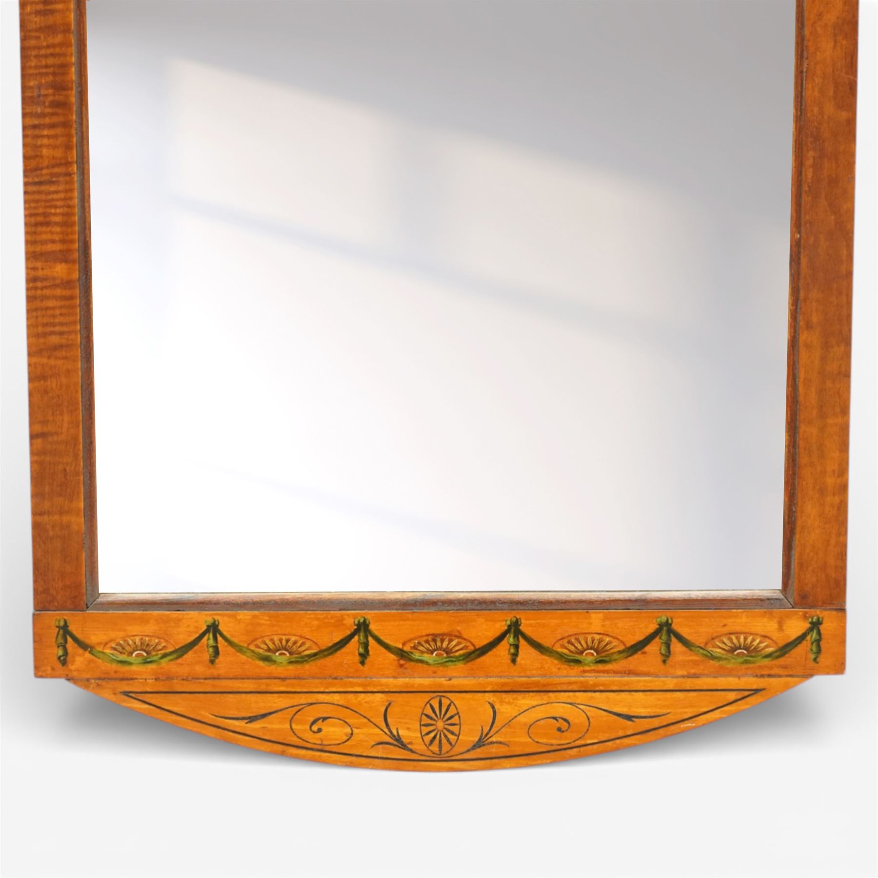 19th century satinwood wall mirror, the rectangular plate within a painted frame decorated with swags, fans and scrolling ornament beneath shaped pediments