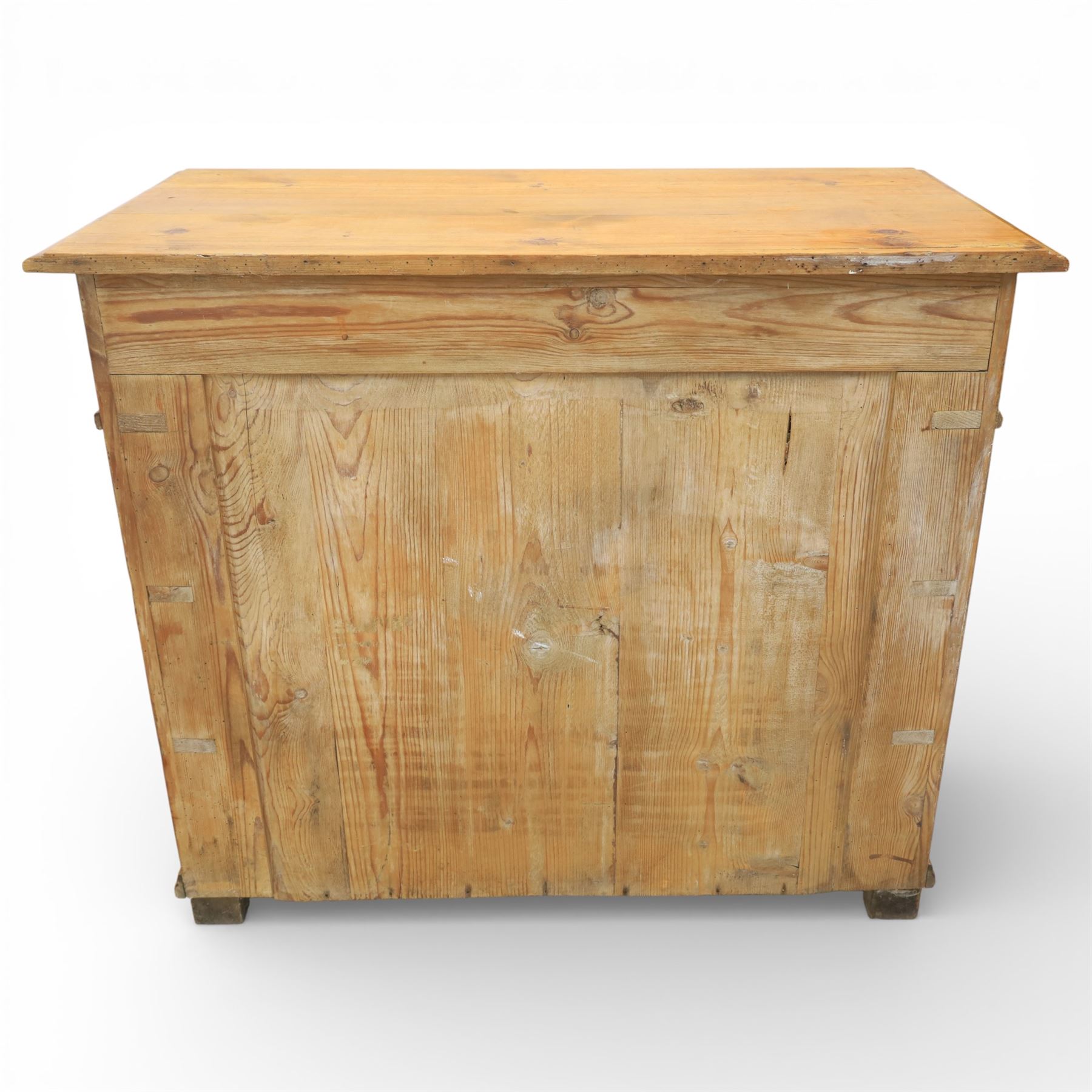 Late Victorian pine chest of drawers, the moulded top above four long drawers with brass drop handles and flower head escutcheons, flanked by pilasters, upon four turned compressed bun feet, 89cm x 103cm x 54cm