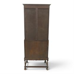 Early 20th century Jacobean Revival oak bureau-bookcase, astragal glazed doors enclosing two adjustable shelves, over geometric panelled fall-front enclosing fitted interior, over two drawers, raised on a spiral-turned base with barley-twist stretchers and compressed bun feet