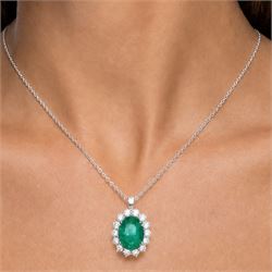 18ct white gold emerald and diamond cluster pendant necklace, single oval cut emerald of approx 4.00 carat, surrounded by fourteen round brilliant cut diamonds, hallmarked, total diamond weight approx 0.85 carat
