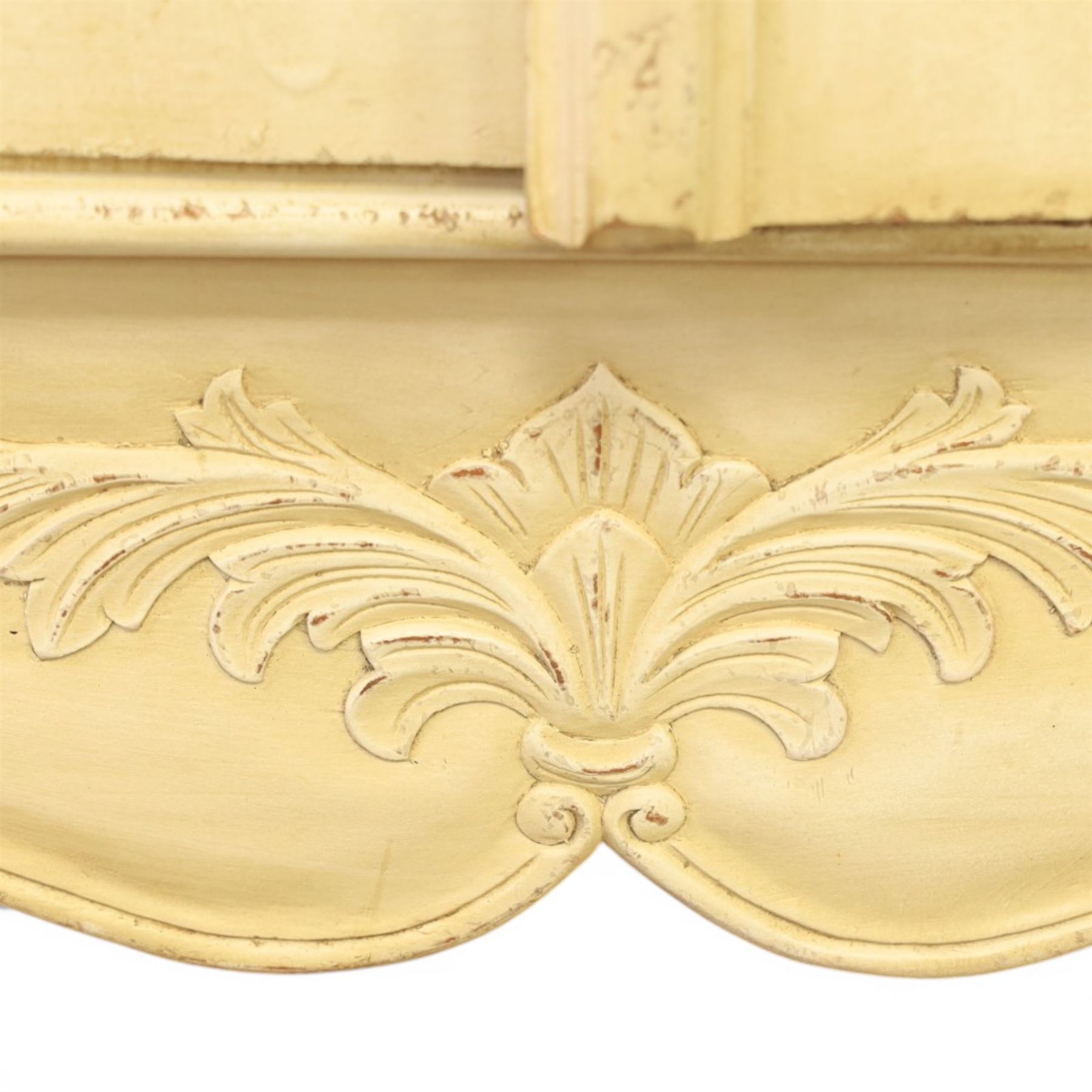 French Louis XV design cream painted double armoire, serpentine moulded pediment surmounted by carved foliate crest, enclosed by two shaped panel doors with applied scroll and leaf mouldings, enclosing a hanging rail and adjustable shelving, fluted uprights with carved floral terminals, on shaped apron and cabriole feet