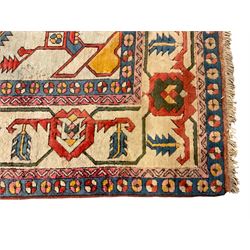 Anatolian Turkish ivory ground carpet, the central geometric pole medallion within an amber field, the guarded border decorated with stylised plant motifs surrounded by bands of repeating flower heads