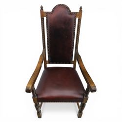 Carolean revival oak dining table and eight chairs (7+1), refectory table with rectangular boarded top and cleated ends, raised on shaped trestle end supports with central stretcher, accompanied by eight high-back chairs including a carver, leather upholstered panels and seats with studwork, on turned legs with stretchers.