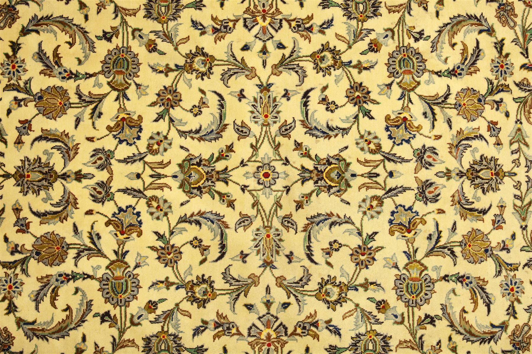 Central Persian Kashan carpet, ivory ground, field with an all-over design of scrolling palmettes and floral sprays in blue and terracotta within a beige ground and pale blue floral border