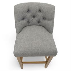Contemporary set of three upholstered bar stools, each with button-tufted grey fabric backrest and seat, raised on light oak finish square legs united by stretchers