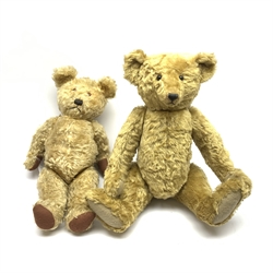 A 1950's plush covered teddy bear, with jointed limbs and glass eyes, together with an Atlantic Bears teddy bear, with jointed limbs, glass eyes and humped back. 