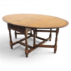 Titchmarsh & Goodwin - 18th century design oak oval drop-leaf dining table with leather dining chairs, the table with drop leaves forming an oval top extending to 180cm, with drawer to either side, raised on turned supports with gateleg, the chairs comprising two carvers in tan leather and two side chairs in green and tan leather backs, brass studded trim with turned uprights and stretchers