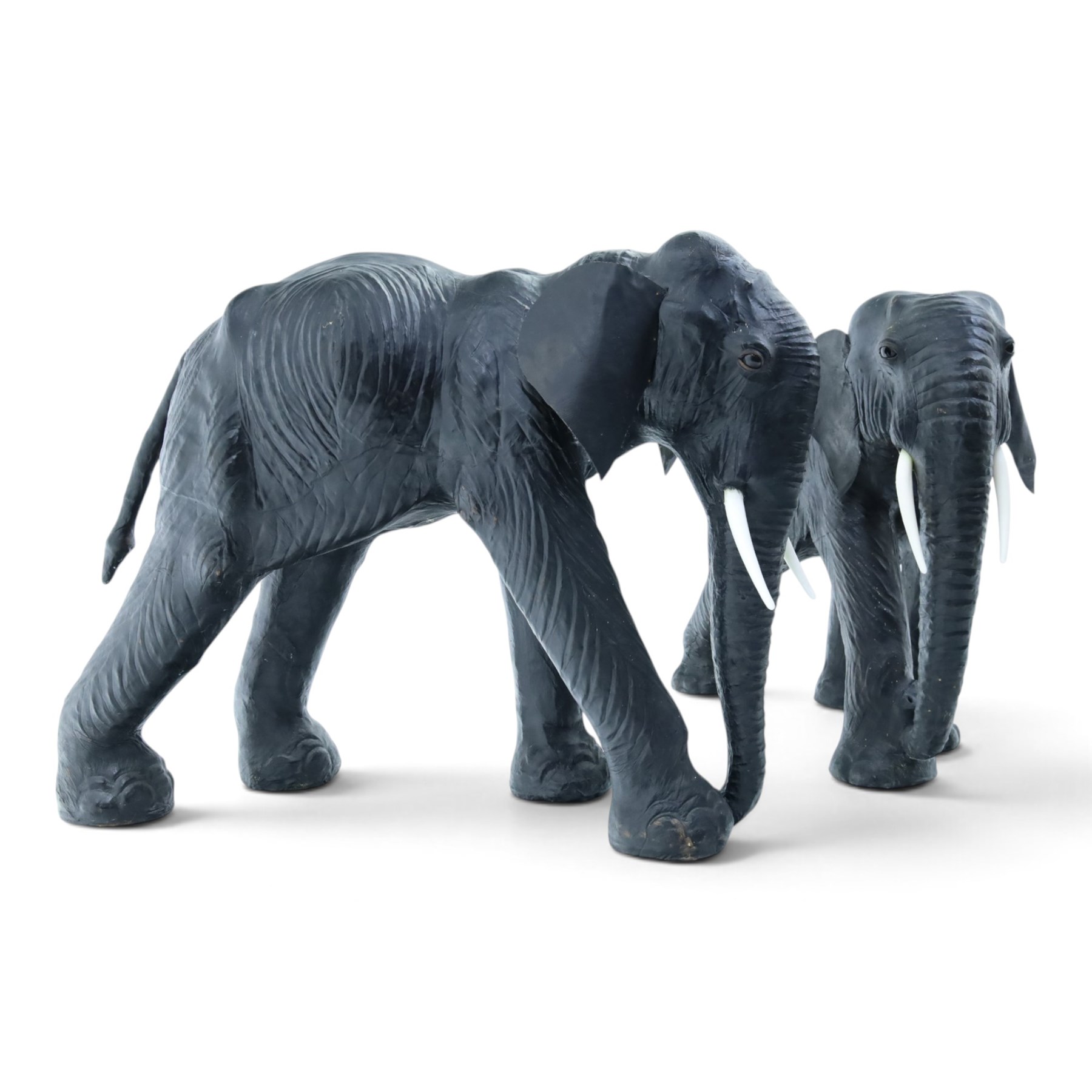In the style of Liberty & Co - pair of 20th century ebonised leather elephants