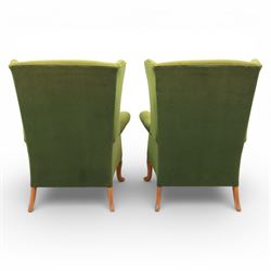 Parker Knoll - pair of 'Penhurst' wingback armchairs upholstered in olive green fabric, on light stained supports 