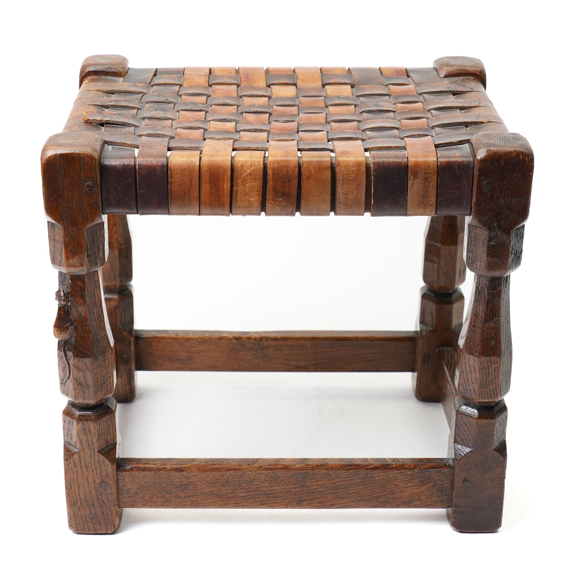 Mouseman - 1930s adzed oak joint stool, leather latticework seat on chamfered octagonal supports, carved with mouse signature, by Robert Thompson of Kilburn
