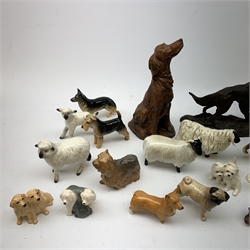 A group of fourteen Beswick dogs, to include Corgi, Pug, Yorkshire Terrirer,  three Spaniels, three Alsatians or German Shepherds, Labrador duo, Old English Sheepdog duo, West Highland Terrier duo, Welsh Terrier, Dalmatian (a/f), together with three Beswick sheep (a/f), and a selection of other dog and sheep figurines. 