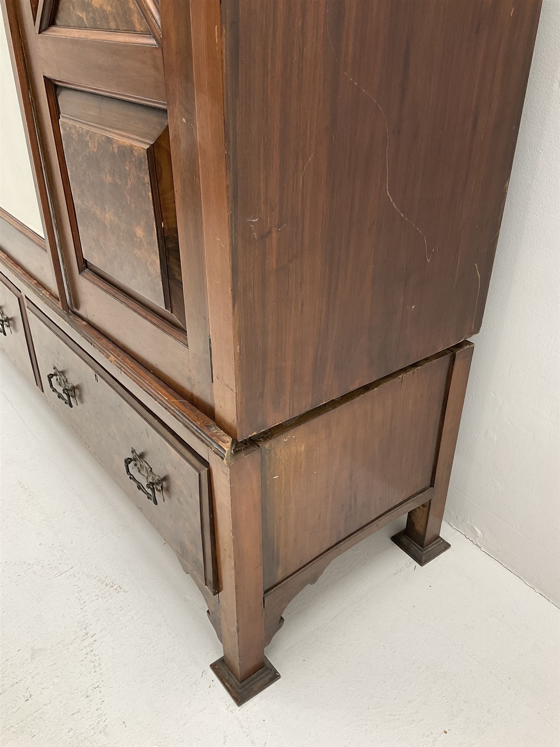Large late Victorian walnut wardrobe, projecting cornice of central bevelled mirror and two panelled doors, two drawers to base