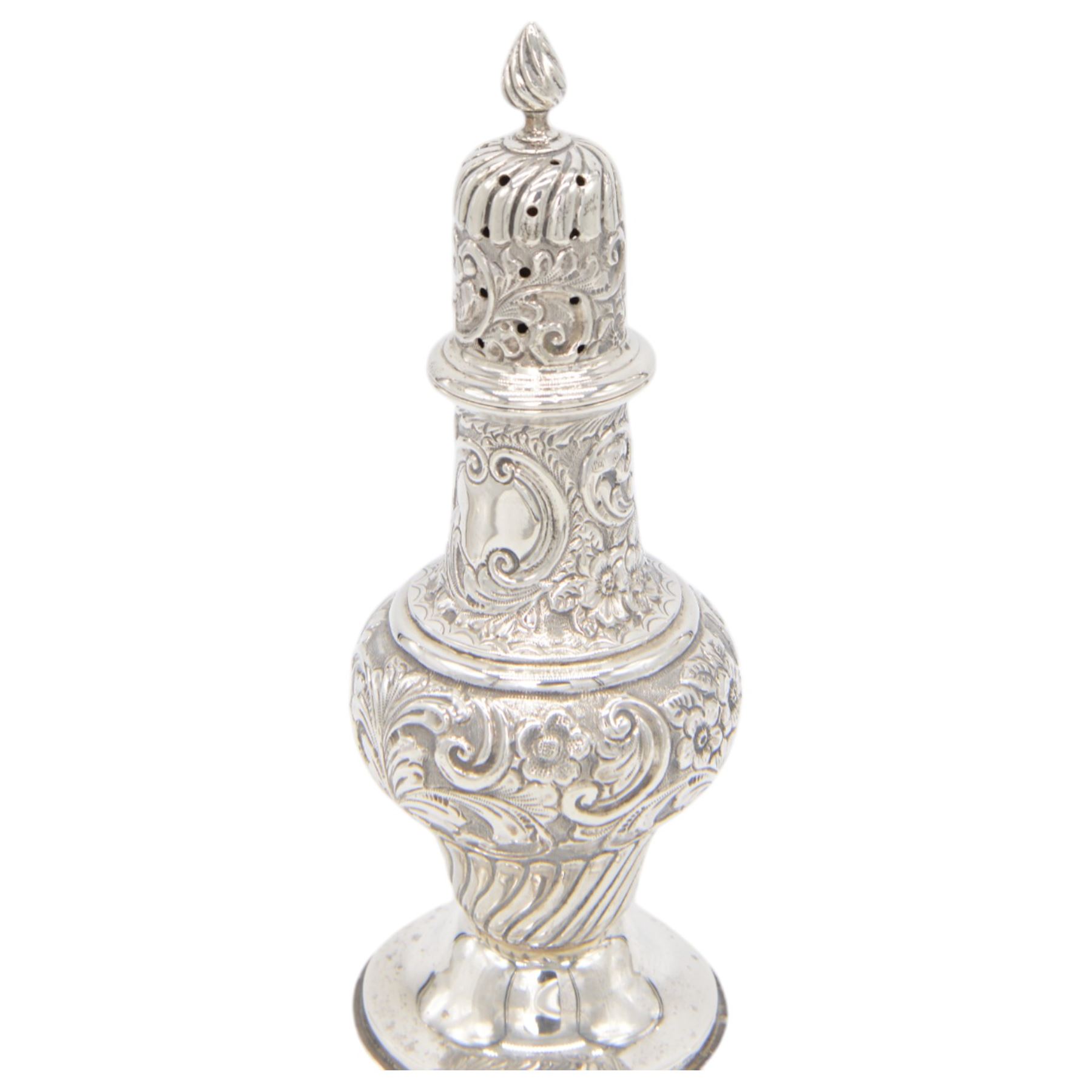 Edwardian silver sugar caster, of typical waisted form profusely embossed with floral and foliate decoration, the removable pierced cover with fluted finial, upon a circular stepped foot, hallmarked William Aitken, Birmingham 1901, H23cm