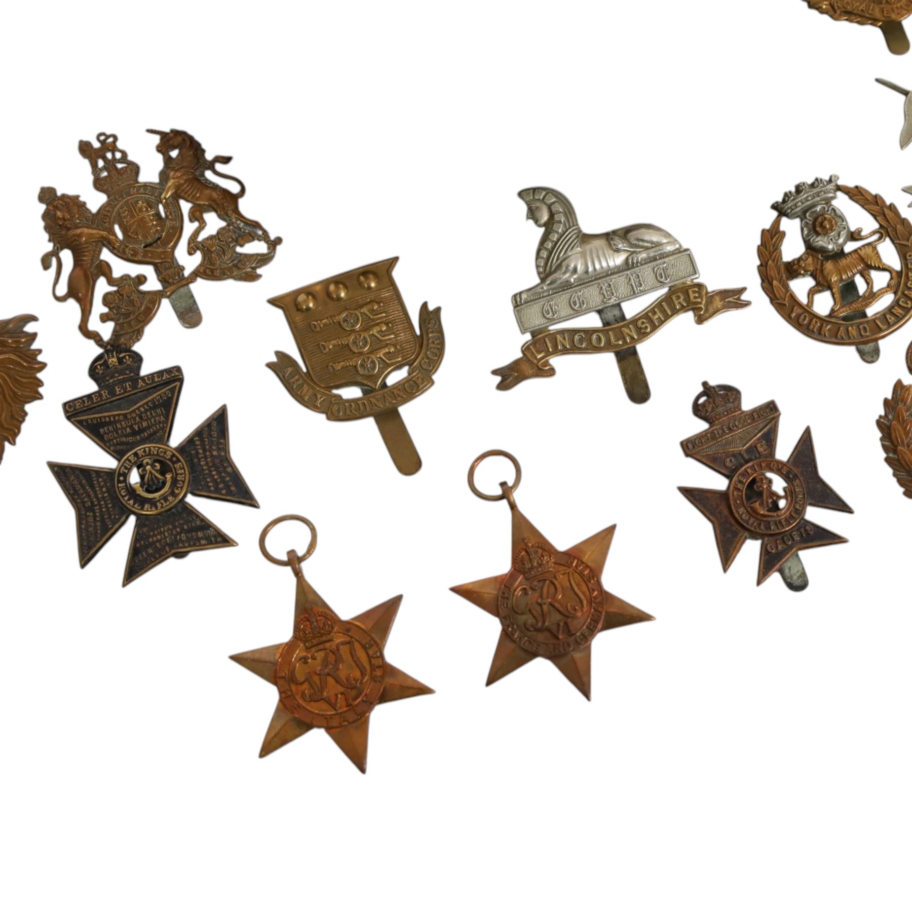 WWII seven British medals, comprising two War medals, two 1939-45 stars, African star, Italy star and French and German star, together with a collection of cap badges including The Kings Royal Rifles, Royal Engineers, East Lancashire, York and Lancaster regiment museum etc  