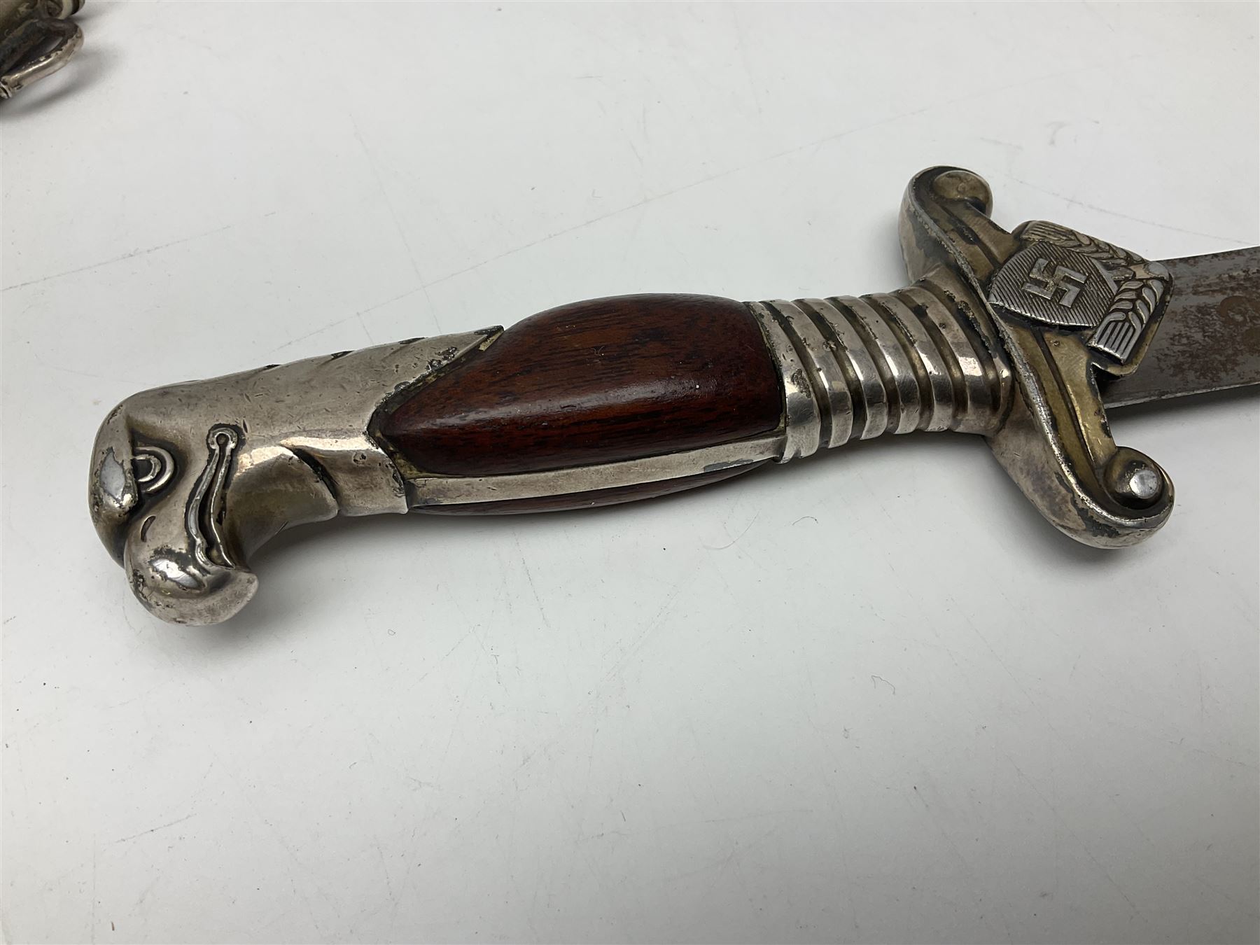 WW2 German RAD (Reichsarbeitdienst) Leader's hewer dagger,  the 25.5cm fullered steel blade engraved Arbeit Adelt (Work Enables) with Eickhorn squirrel maker's mark; scrolling cross-piece, mahogany grip and eagle pommel; in decorative plated scabbard L40cm overall.