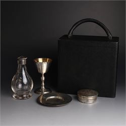 Mid 20th century silver travelling communion set, comprising goblet, paten and pyx, all hallmarked Hurst, Franklin & Co Ltd, London 1961 & 1962, with a glass bottle with unmarked cover, all within a tooled leather fitted case, goblet H9cm