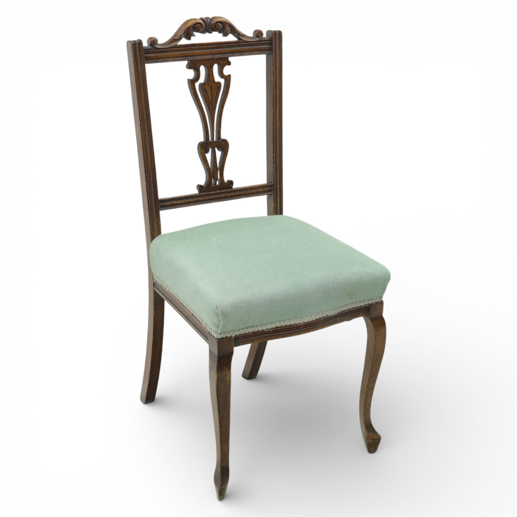 Late Victorian mahogany side chair, the carved cresting rail above a pierced and carved splat with lyre-form detail, the back panel inset with cane work, drop-in upholstered seat in pale green fabric with braid trim, raised on cabriole supports