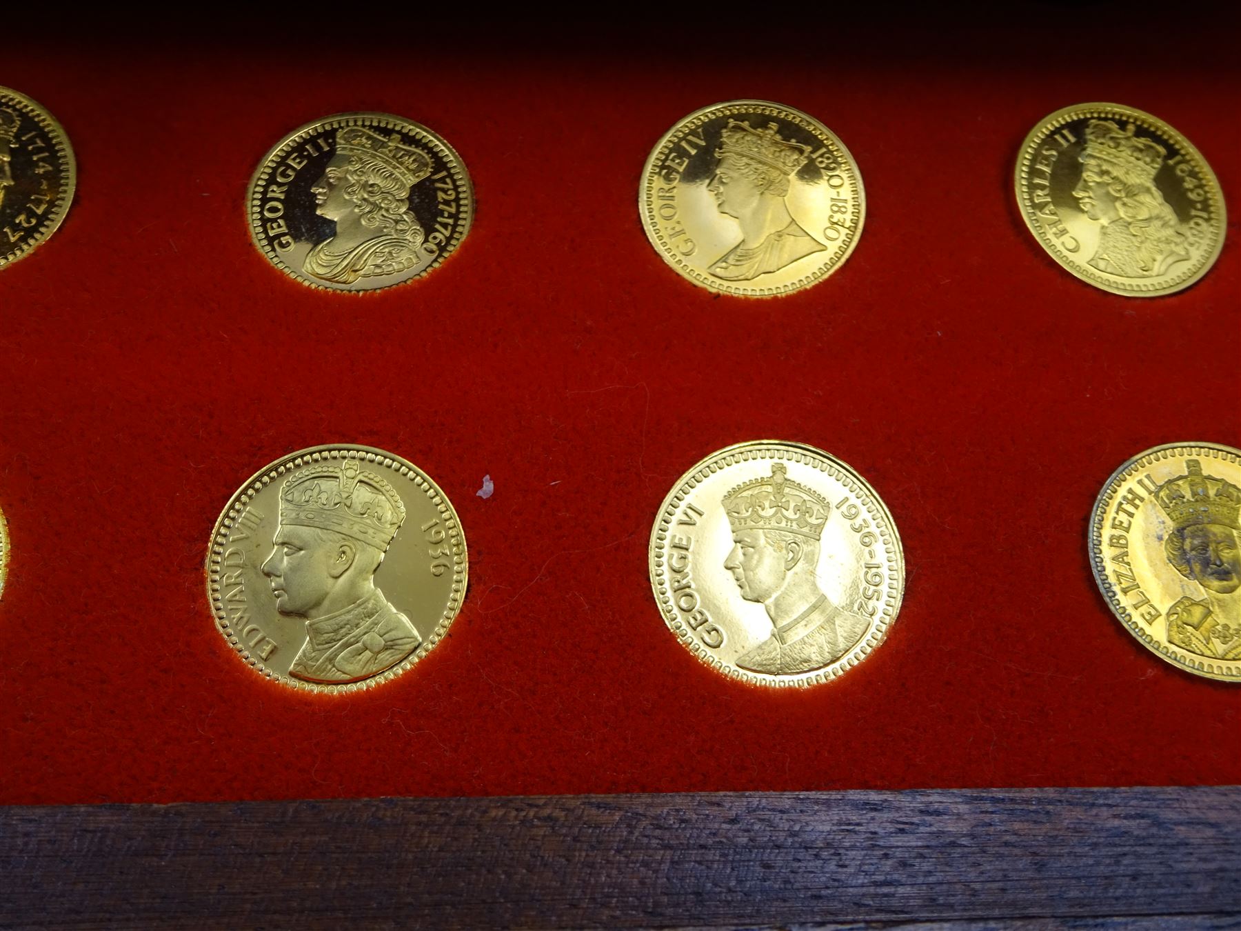 Danbury Mint, Our Royal Sovereigns Collection, seventy 22 carat gold plated silver medallions depicting the complete line of British monarchs to mark the 1200th anniversary of the first coronation, contained within wooden table top collectors cabinet with two drawers, with certificate of authenticity, with two drawers, hallmarked Danbury Mint, London various dates
