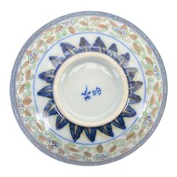 Chinese late Qing Dynasty Guangxu period rice grain detailed teabowl and saucer, each decorated in underglaze blue with flowers and foliate borders, and further detailed with iron red and pale green band of flower heads, and scrolling bands, teabowl with apocryphal Kangxi mark beneath and saucer with apocryphal Qianlong mark beneath, teabowl H5cm, saucer D10cm